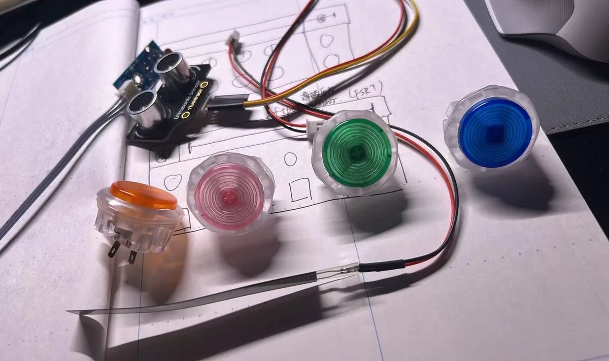 Hand-drawn controller layout with the actual orange, pink, green and blue arcade buttons, an ultrasonic sensor and an FSR placed on the paper.
